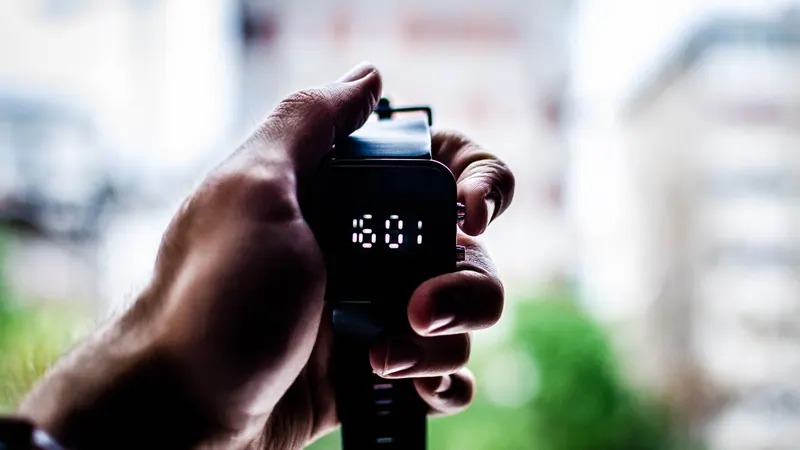 Hand holding a stopwatch – time is money