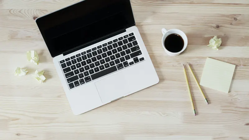 Laptop and coffee on a wooden desk