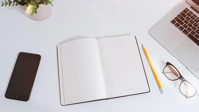 Desk with notebook, smartphone and laptop for budgeting